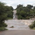 A damaged road following heavy rain at the Kruger National Park in Mpumalanga, earlier this year. Image credit: Reuters/Oupa Nkosi