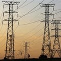 A man walks beneath electricity pylons in Orlando, Soweto. Image credit: Reuters/Siphiwe Sibeko